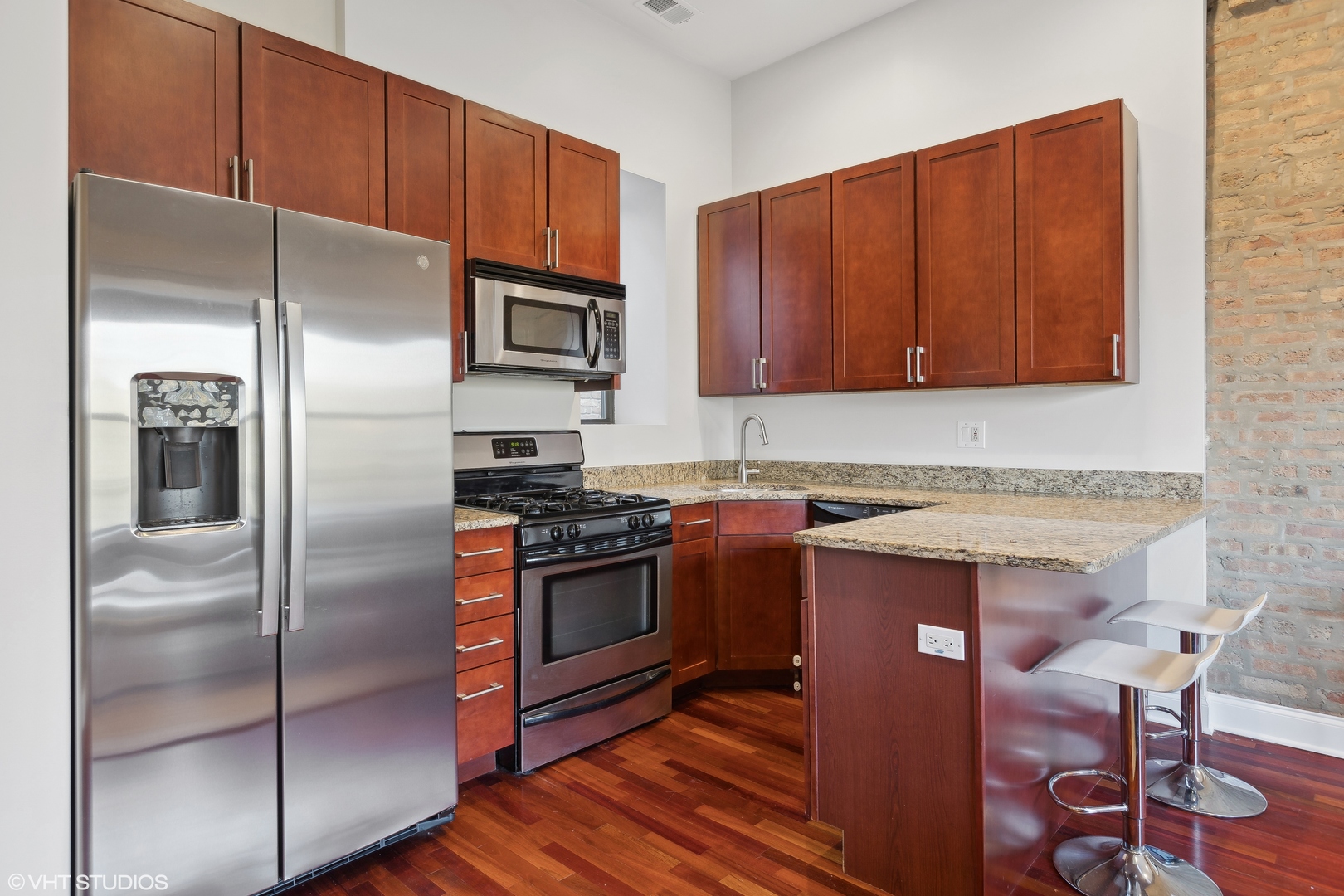 1965 West Cullom Avenue, Unit 3 Chicago, IL 60613 - Photo 9 of 19 a kitchen with stainless steel appliances granite countertop a refrigerator stove and sink