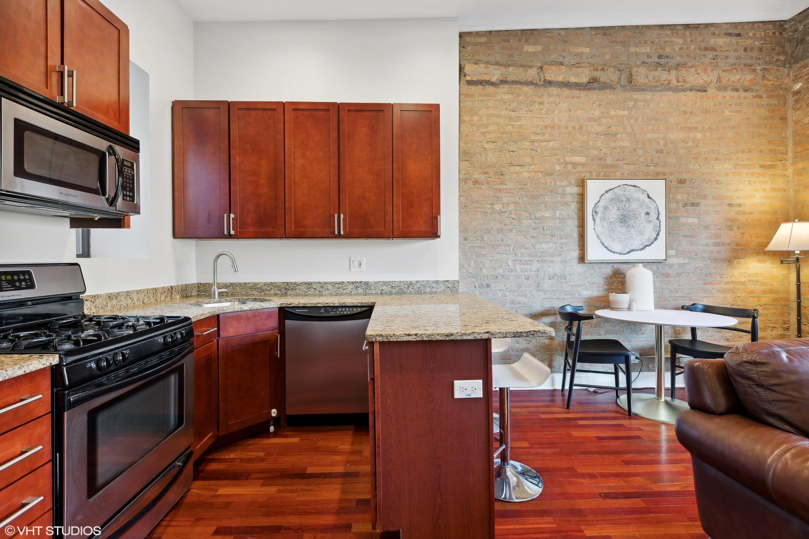 1965 West Cullom Avenue, Unit 3 Chicago, IL 60613 - Photo 10 of 19 a kitchen with stainless steel appliances granite countertop a stove top oven a sink dishwasher and wooden cabinets
