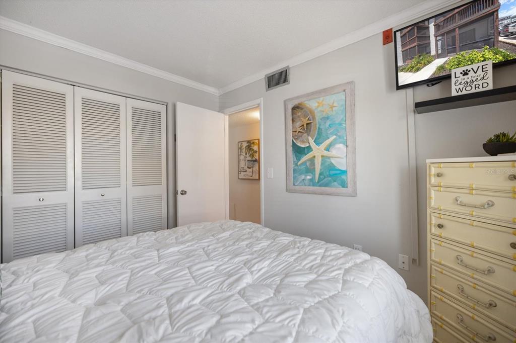 1604 Stickney Point Road, Unit 4102 Sarasota, FL 34231 - Photo 12 of 30 a bedroom with a bed and a window