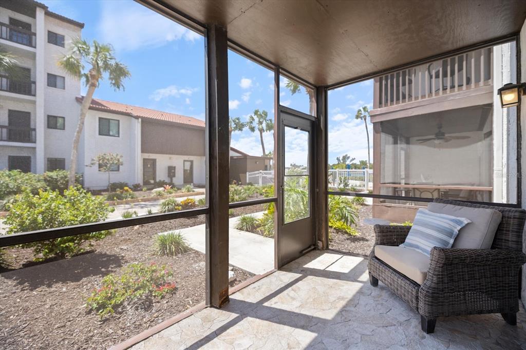 1604 Stickney Point Road, Unit 4102 Sarasota, FL 34231 - Photo 17 of 30 a view of a porch with furniture and floor to ceiling window