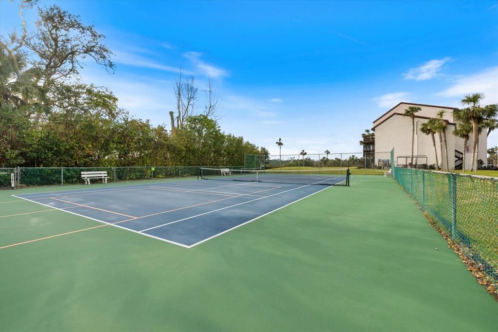 1604 Stickney Point Road, Unit 4102 Sarasota, FL 34231 - Photo 23 of 30 a view of an outdoor space and tennis court