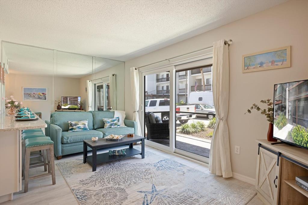 1604 Stickney Point Road, Unit 4102 Sarasota, FL 34231 - Photo 4 of 30 a living room with furniture and a window