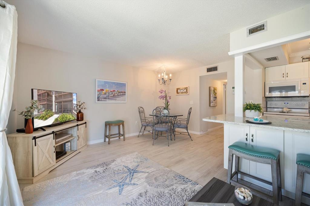 1604 Stickney Point Road, Unit 4102 Sarasota, FL 34231 - Photo 7 of 30 a living room with furniture a rug and white walls