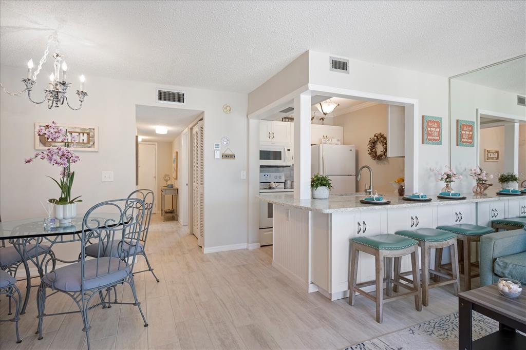 1604 Stickney Point Road, Unit 4102 Sarasota, FL 34231 - Photo 8 of 30 a view of a dining room kitchen and a wooden floor