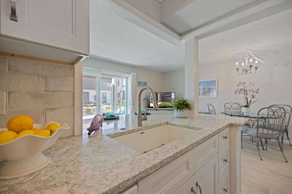 1604 Stickney Point Road, Unit 4102 Sarasota, FL 34231 - Photo 9 of 30 a bathroom with a granite countertop sink and a mirror