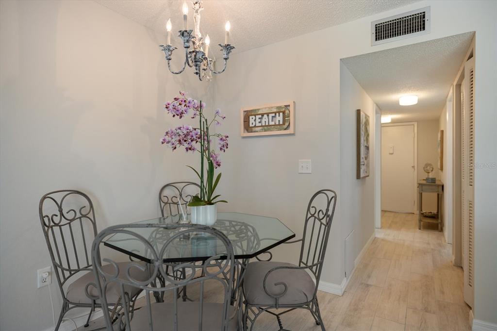 1604 Stickney Point Road, Unit 4102 Sarasota, FL 34231 - Photo 10 of 30 a view of a dining room with furniture and chandelier