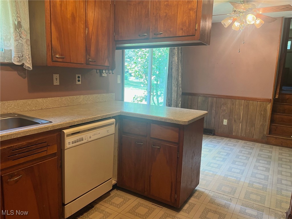 10504 Mulberry Road Chardon, OH 44024 - Photo 16 of 23 Kitchen featuring wooden walls, light countertops, and a peninsula
