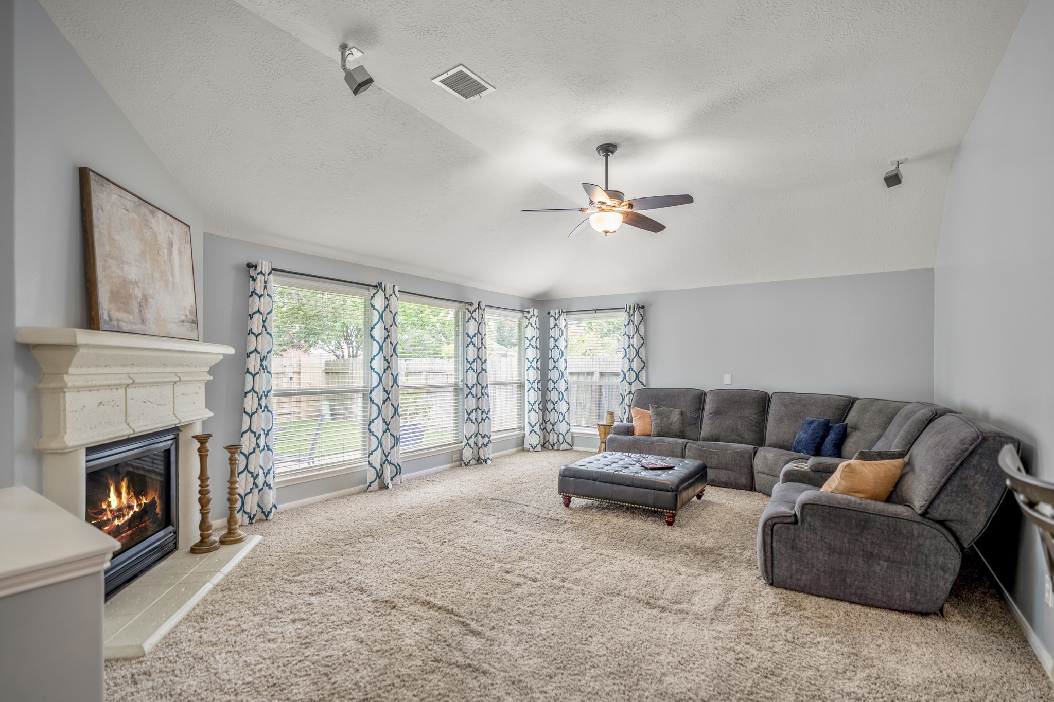 3411 Utah Beach Court Spring, TX 77388 - Photo 15 of 50 Here, the family room continues the back-of-home gathering space, with patio access on the left bringing in natural light and keeping the backyard close. Ceiling speakers remain in place for surround sound, while the breakfast room and kitchen sit just beyond, allowing this room to feel relaxed without being disconnected from the main flow of the home.