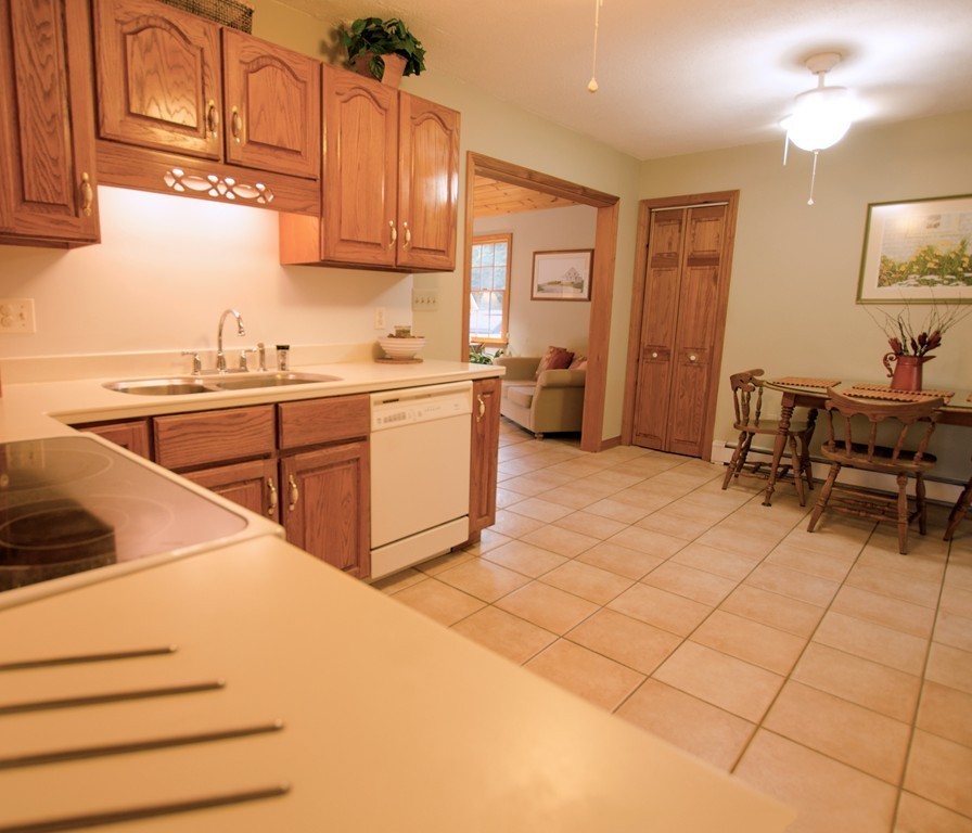 19 Mattapoisett Road Acushnet, MA 02743 - Photo 5 of 18 a kitchen with stainless steel appliances kitchen island granite countertop a sink and cabinets