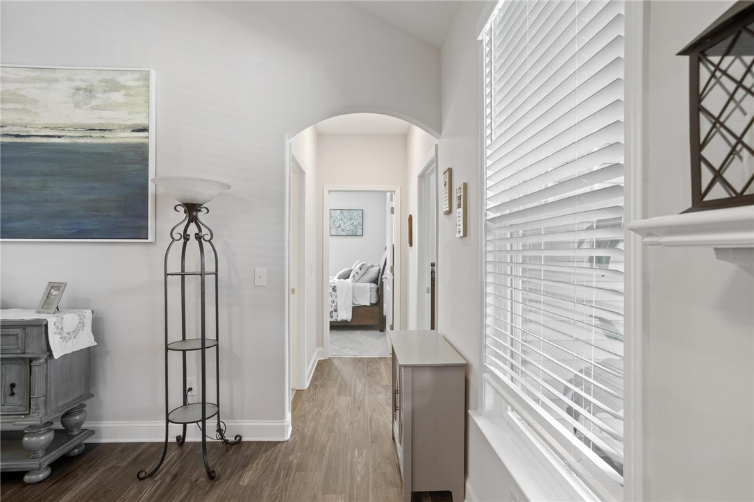 125 Estateside Drive Anderson, SC 29621 - Photo 25 of 37 Hardwood-style flooring and arched doorways define this inviting hallway, leading to a serene bedroom.