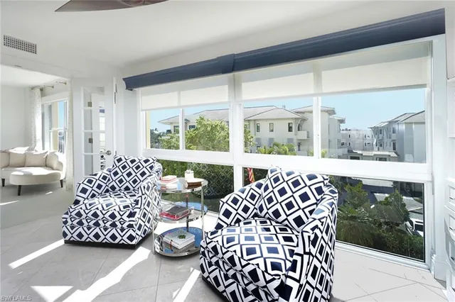 a living room with a large window and furniture