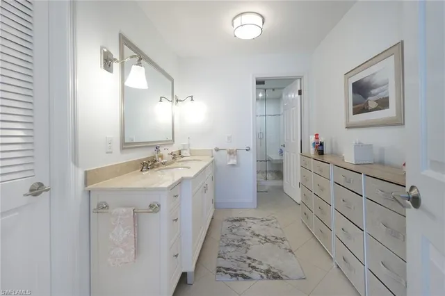 a spacious bathroom with a double vanity sink a mirror and a