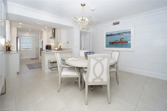 a view of a dining room with furniture and chandelier
