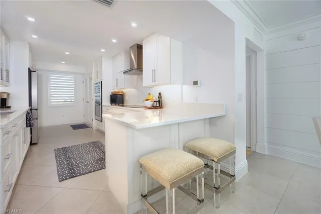 a kitchen with a sink cabinets and window