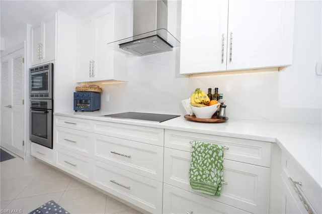 a kitchen with a white cabinet and a dishwasher
