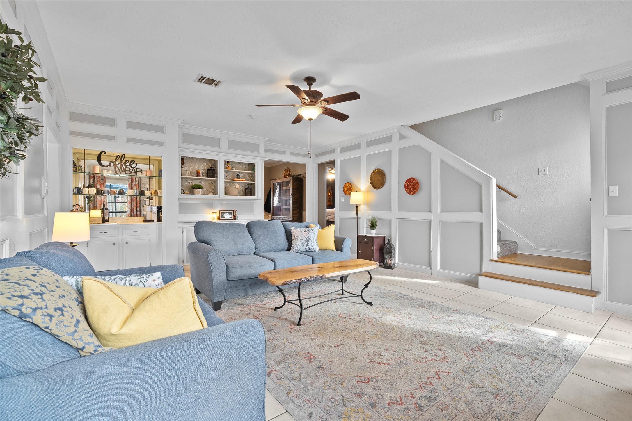 41 Windsor Drive Conroe, TX 77304 - Photo 11 of 39 An additional view of the living area shows the flow toward the staircase and built-in display cabinetry, adding both function and charm. The open feel makes the space easy to furnish and personalize.
