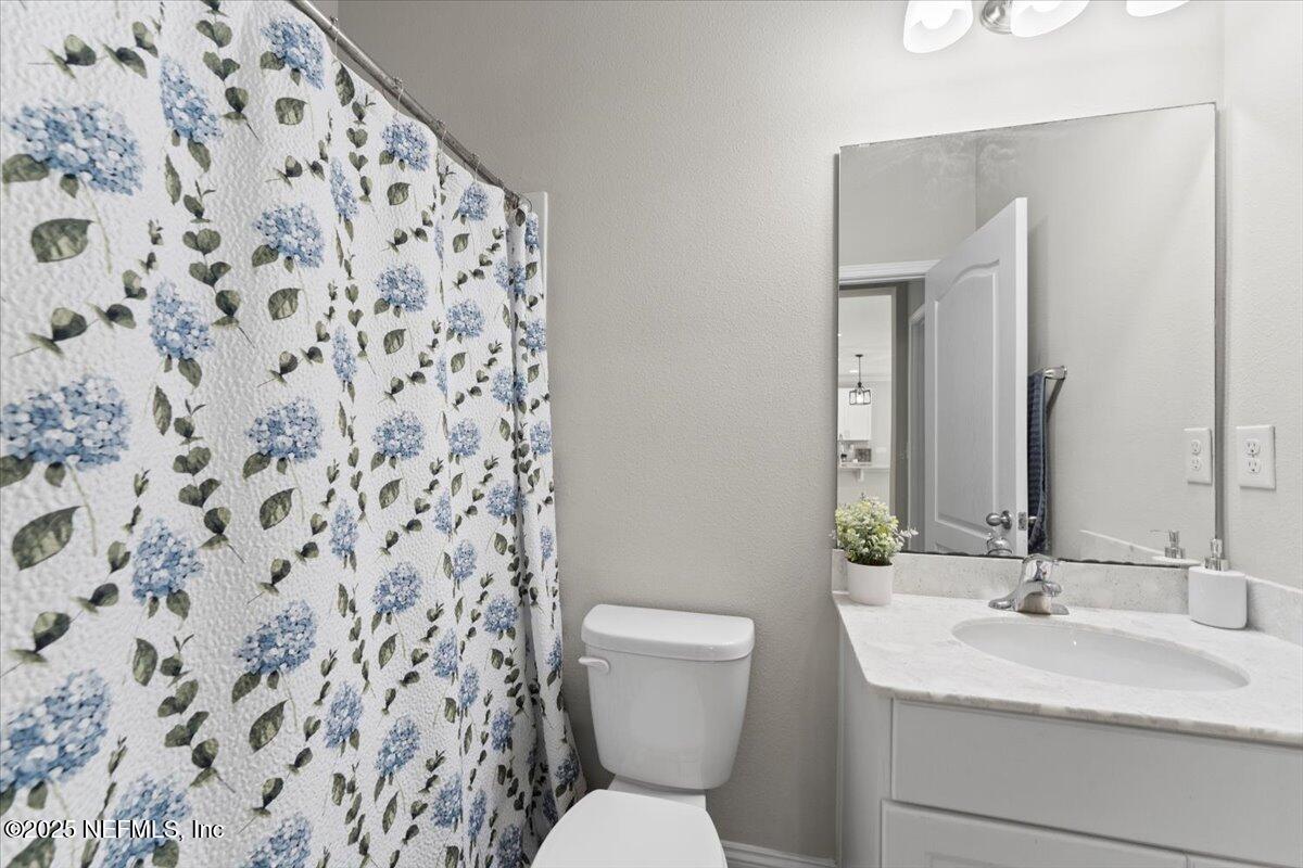 3060 Free Bird Loop Green Cove Springs, FL 32043 - Photo 17 of 94 a bathroom with a toilet and a sink a mirror