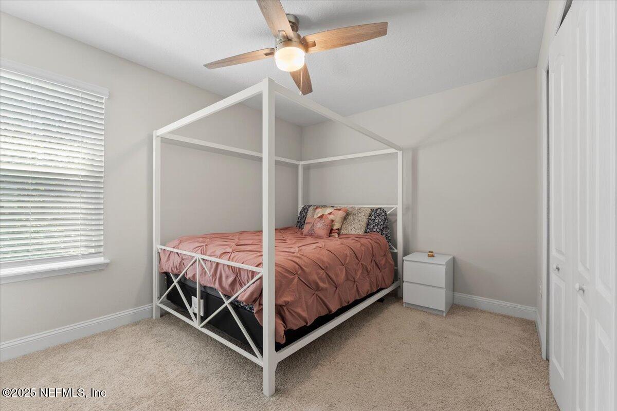 3060 Free Bird Loop Green Cove Springs, FL 32043 - Photo 26 of 94 a bed room with a bed and a ceiling fan