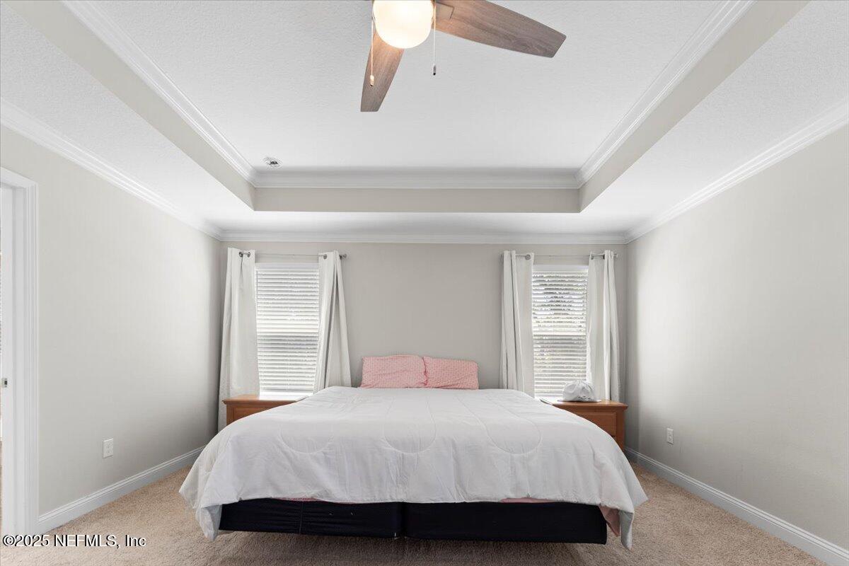 3060 Free Bird Loop Green Cove Springs, FL 32043 - Photo 32 of 94 a bedroom with a large bed and a window