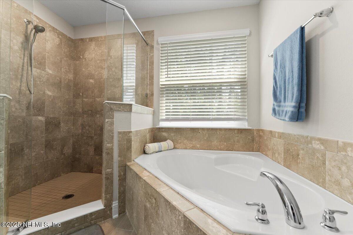 3060 Free Bird Loop Green Cove Springs, FL 32043 - Photo 34 of 94 a white bath tub sitting next to a shower
