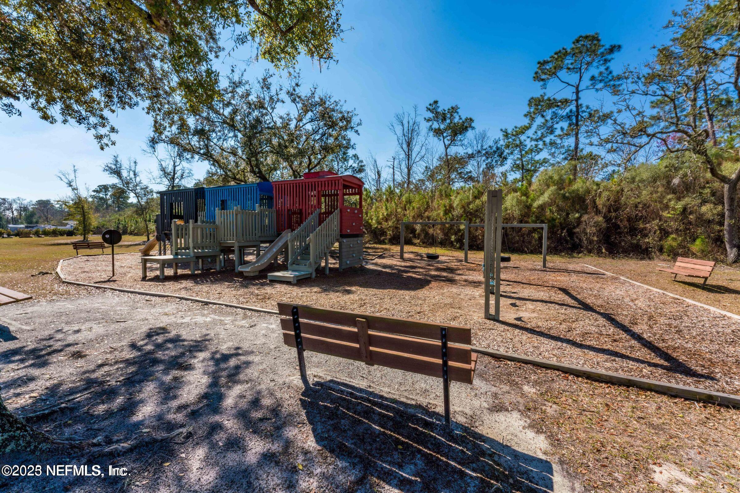 3060 Free Bird Loop Green Cove Springs, FL 32043 - Photo 82 of 94 a view of a park with swings and slides