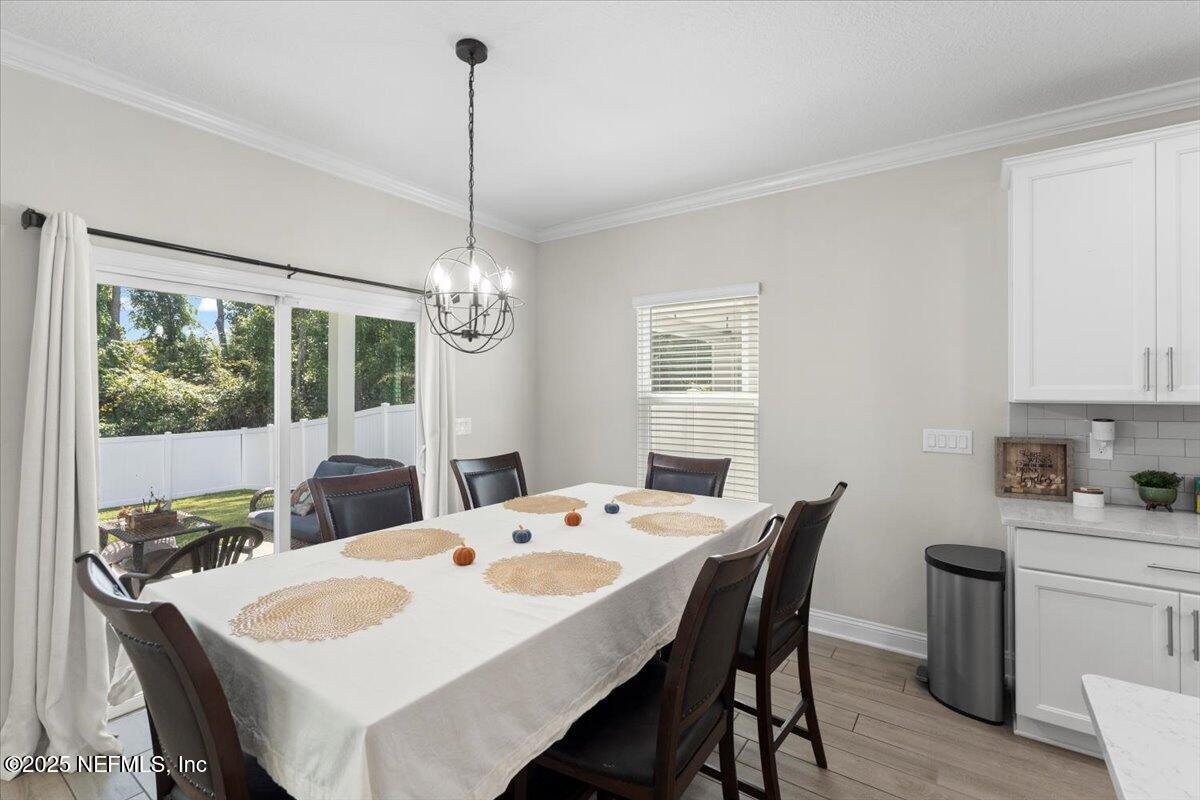 3060 Free Bird Loop Green Cove Springs, FL 32043 - Photo 9 of 94 a dining room with furniture a chandelier and window