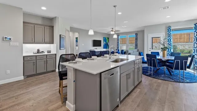 a kitchen with a sink stove top oven and cabinets