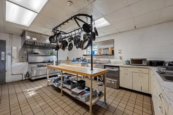 a kitchen with stainless steel appliances a sink a stove and cabinets