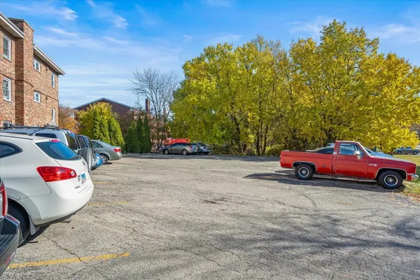 a view of city with cars parked