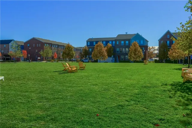 a garden with tall buildings in the background