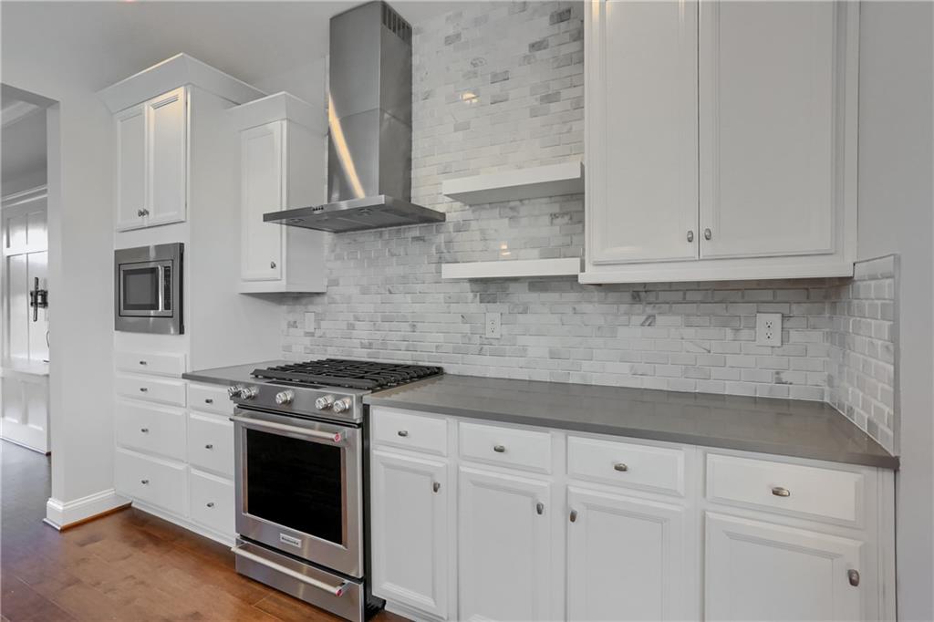 602 Gratitude Road Cranberry Township, PA 16066 - Photo 9 of 29 a kitchen with stainless steel appliances granite countertop white cabinets and a stove