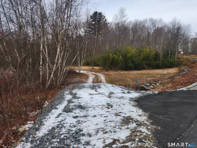 a wooden bench with view of trees