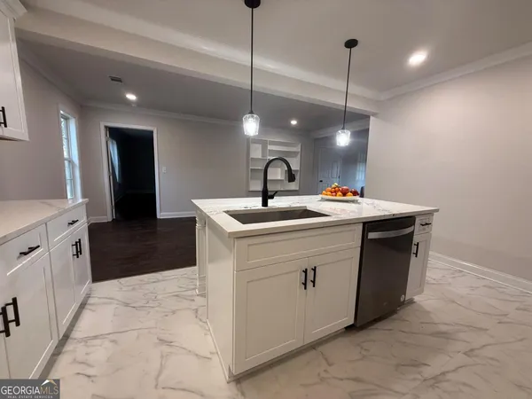 a utility room with sink dryer and washer