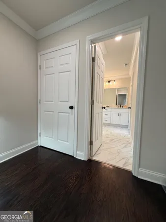 a view of a hallway with wooden floor