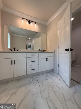 a spacious bathroom with a sink and a mirror