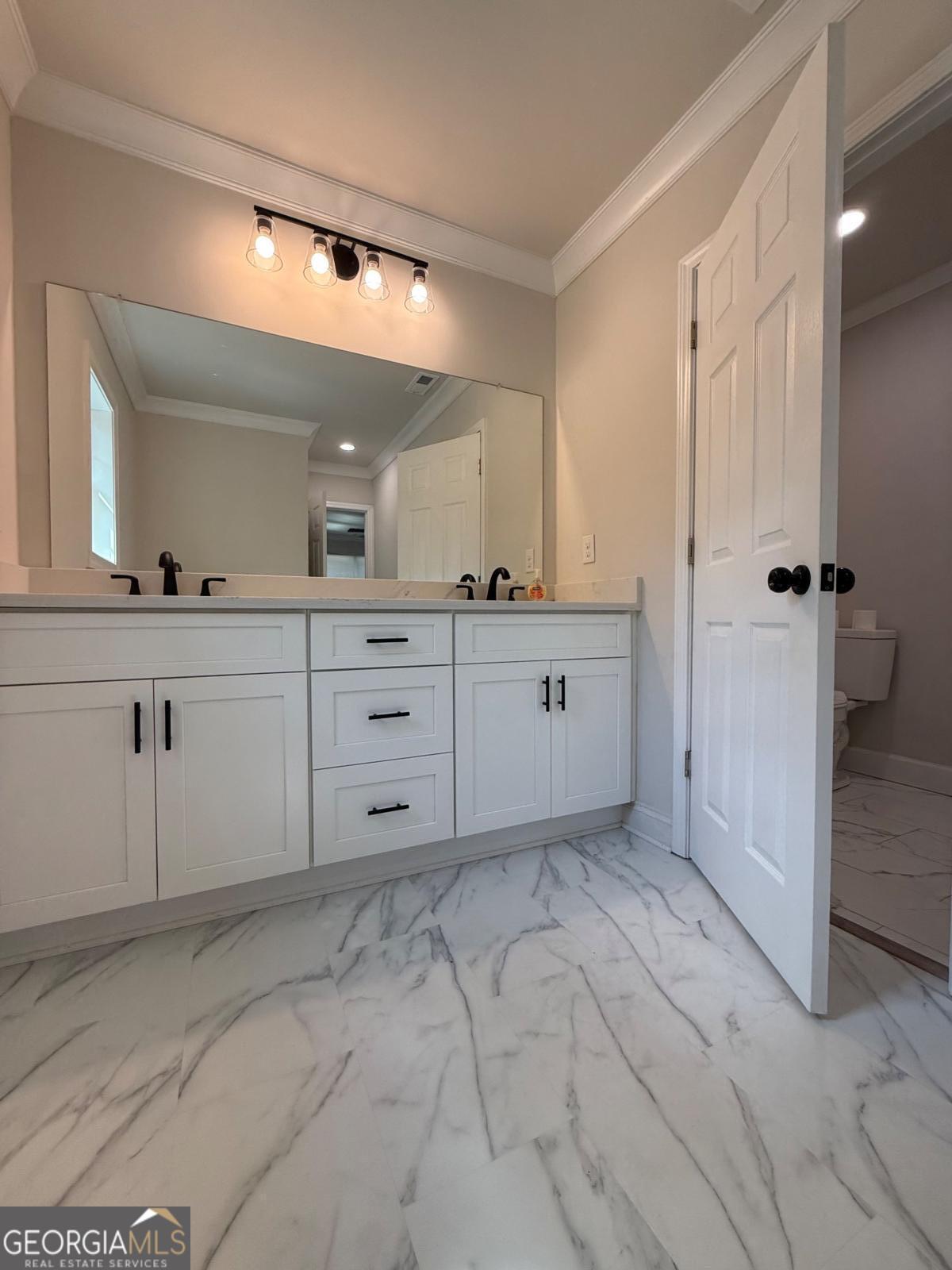 213 Fair Street Baxley, GA 31513 - Photo 19 of 29 a spacious bathroom with a sink and a mirror