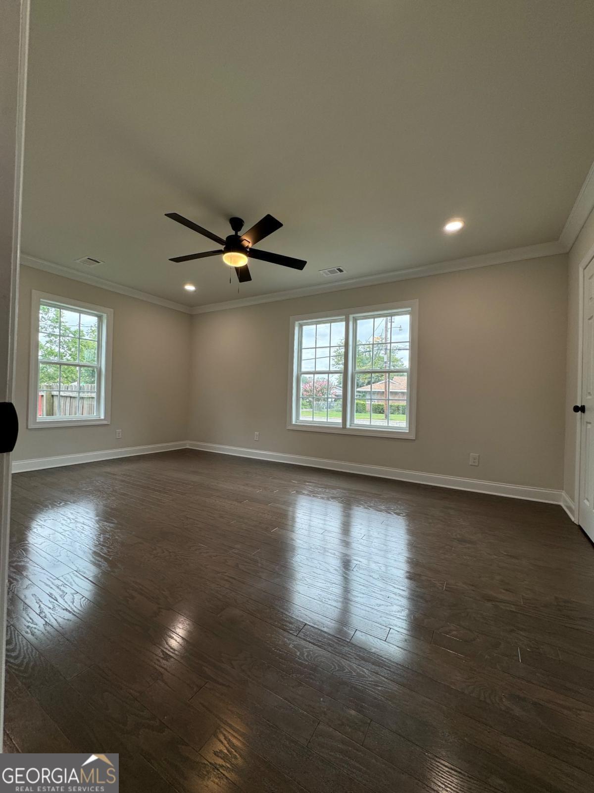 213 Fair Street Baxley, GA 31513 - Photo 23 of 29 a view of an empty room with wooden floor and a window