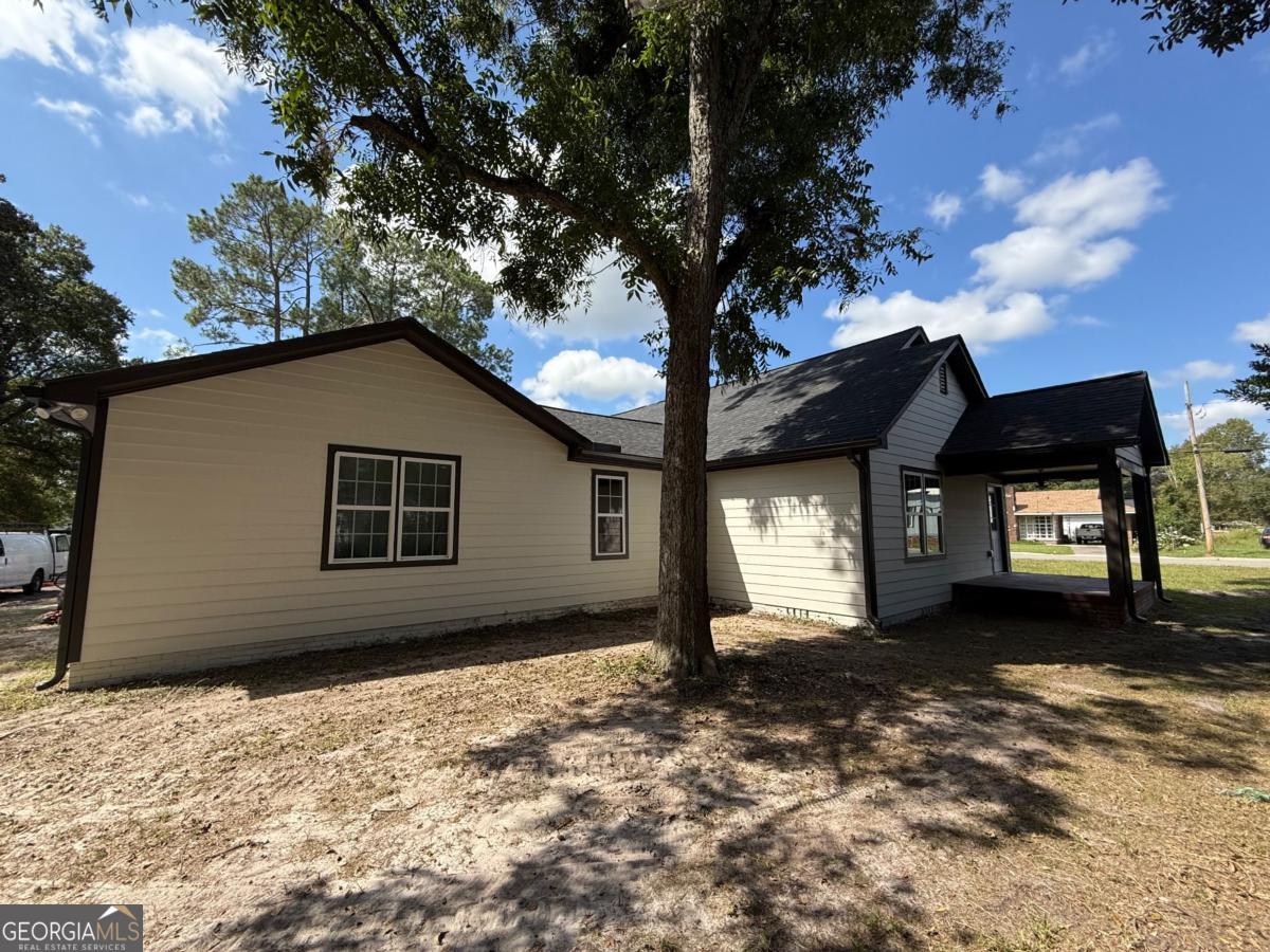 213 Fair Street Baxley, GA 31513 - Photo 28 of 29 a house that has a tree in front of it