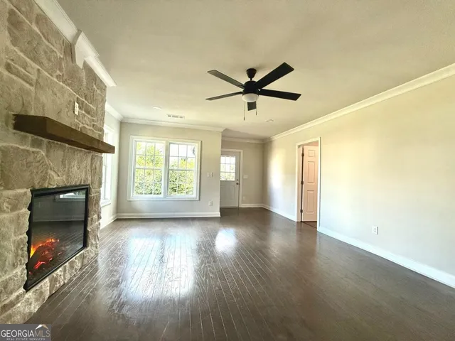 a view of a room with wooden floor and a fireplace