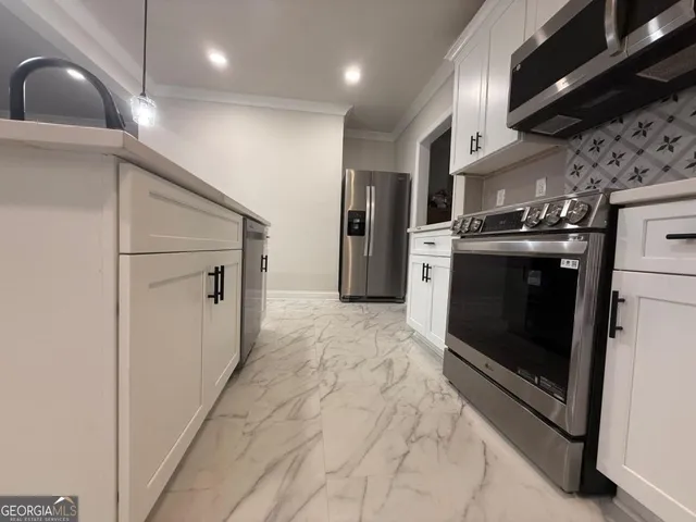 a view of a kitchen with a sink refrigerator and window
