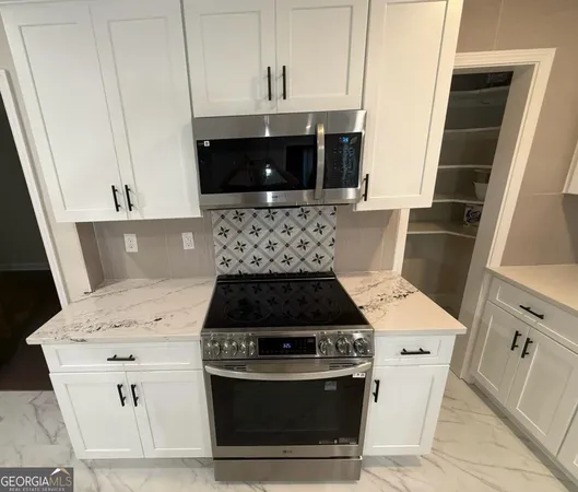 a stove top oven sitting inside of a kitchen