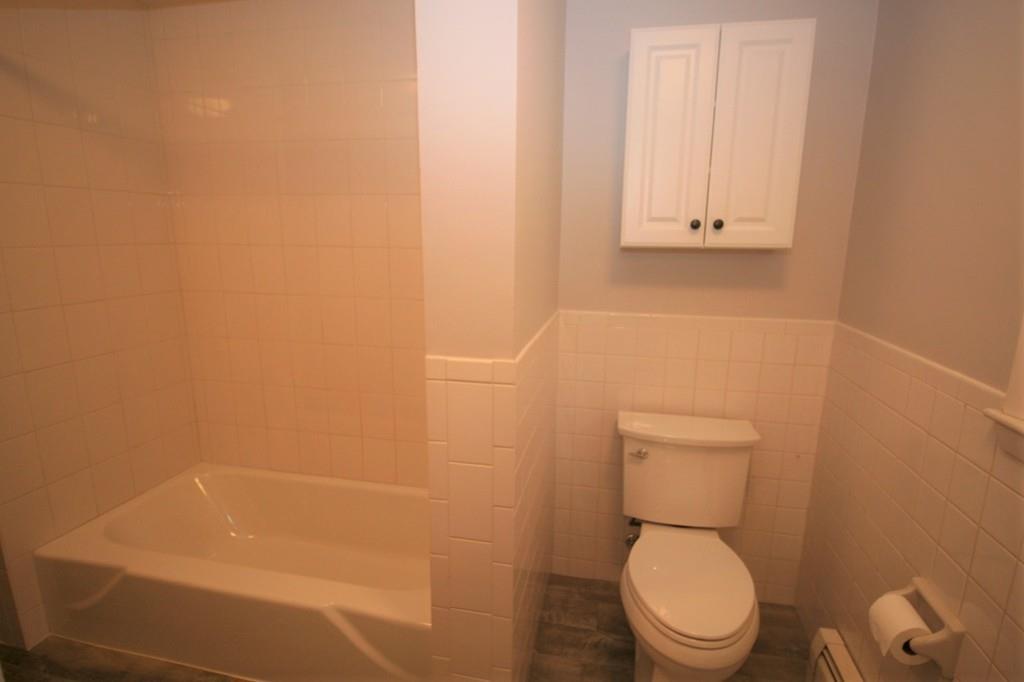 10 Silverbrook Road Topsfield, MA 01983 - Photo 12 of 25 a white toilet sitting next to a shower