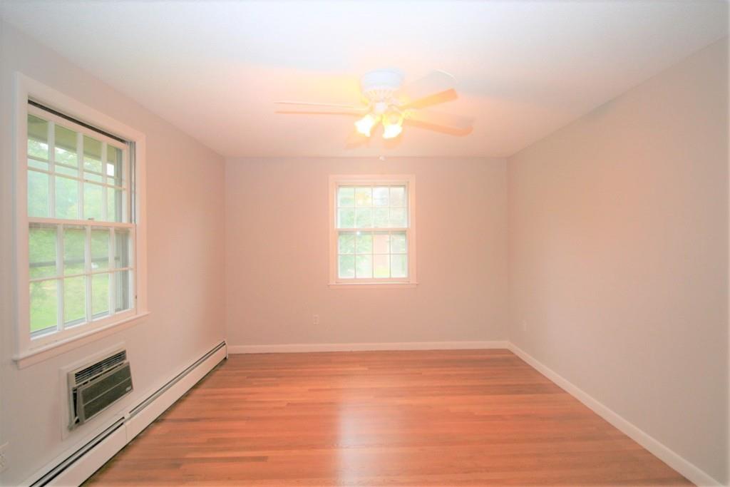 10 Silverbrook Road Topsfield, MA 01983 - Photo 13 of 25 an empty room with wooden floor and windows