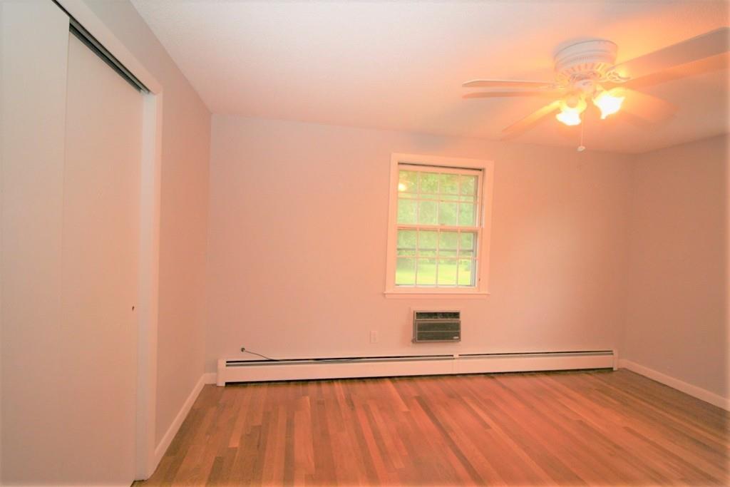 10 Silverbrook Road Topsfield, MA 01983 - Photo 14 of 25 a view of an empty room with wooden floor and a window