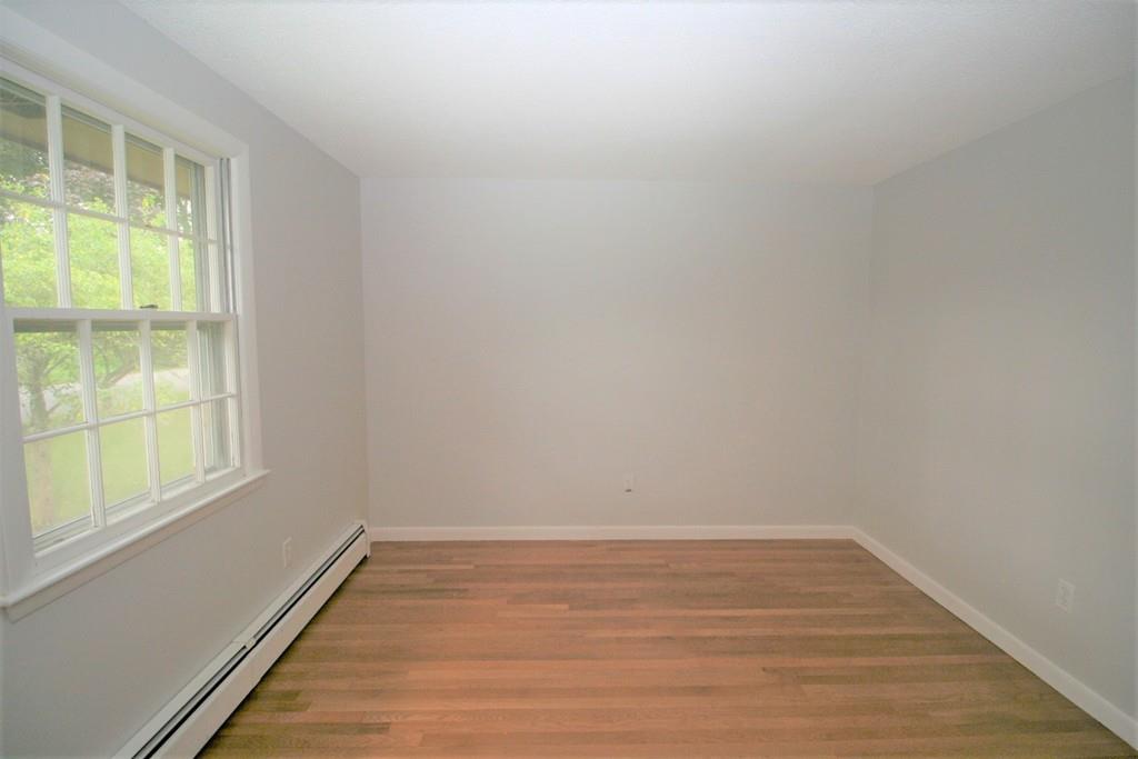 10 Silverbrook Road Topsfield, MA 01983 - Photo 16 of 25 a view of an empty room with wooden floor and a window