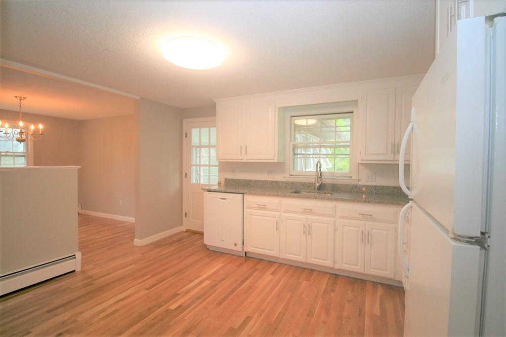 10 Silverbrook Road Topsfield, MA 01983 - Photo 4 of 25 a kitchen with granite countertop white cabinets and wooden floor
