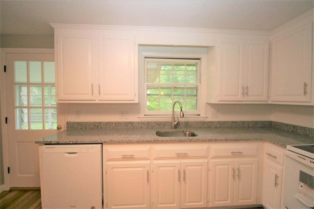 10 Silverbrook Road Topsfield, MA 01983 - Photo 5 of 25 a kitchen with granite countertop white cabinets and a window