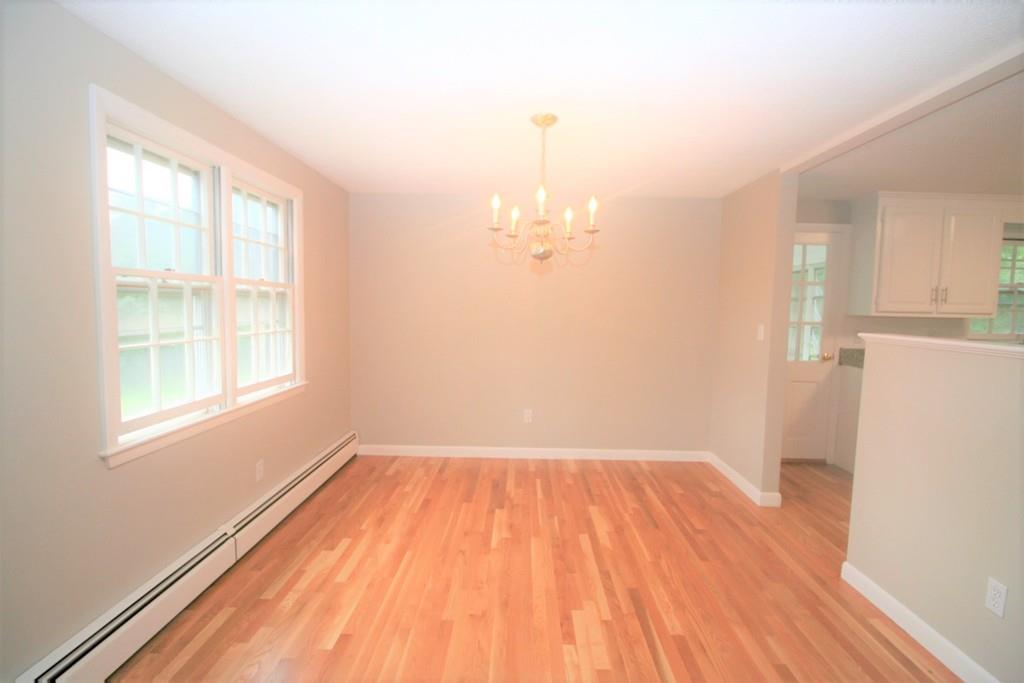 10 Silverbrook Road Topsfield, MA 01983 - Photo 7 of 25 an empty room with wooden floor and windows