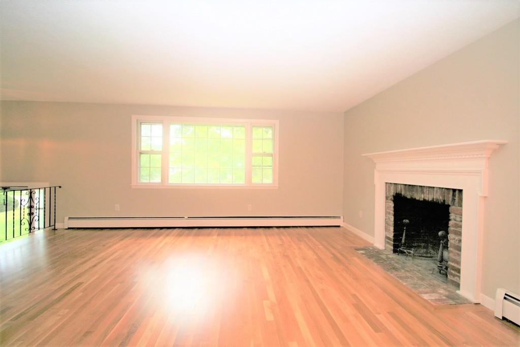 10 Silverbrook Road Topsfield, MA 01983 - Photo 8 of 25 a view of an empty room with wooden floor and a window