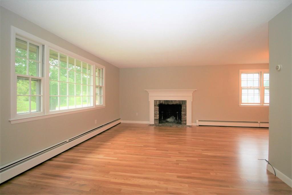 10 Silverbrook Road Topsfield, MA 01983 - Photo 9 of 25 a view of an empty room with wooden floor and a window
